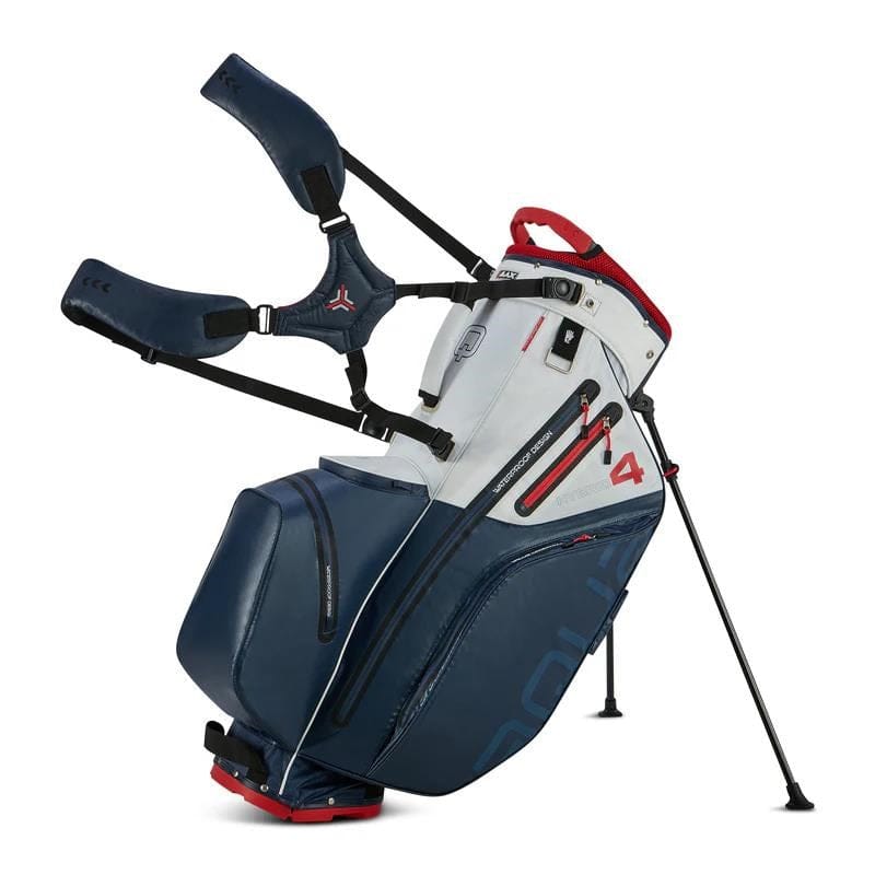Golf-Standbag in Navy, Weiß und Rot mit mehreren Taschen und stabilen Standbeinen.