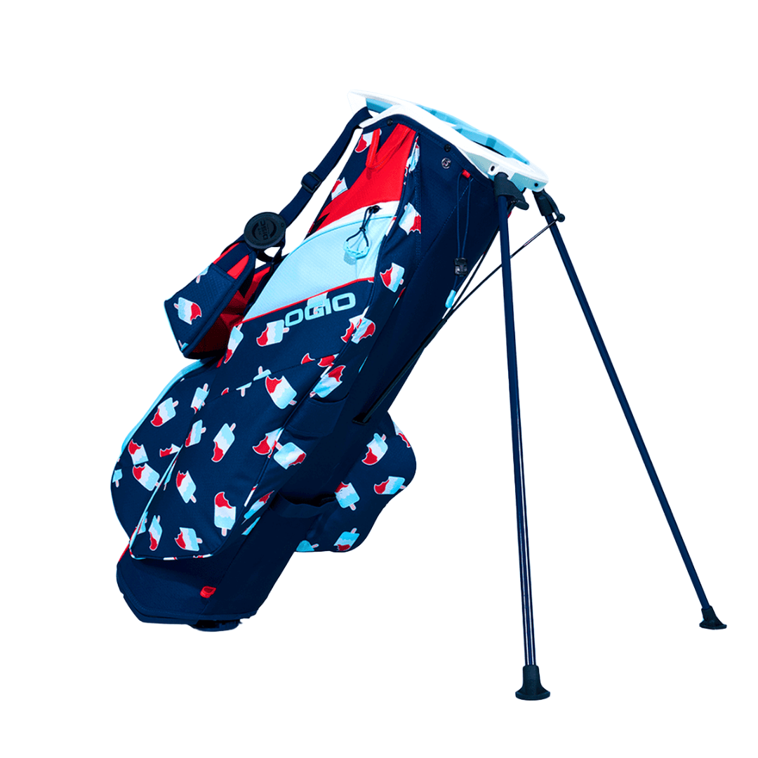 Schwarzes OGIO Fuse Stand Golfbag mit weiß-roten Eis am Stiel Muster und ausklappbarem Ständer.
