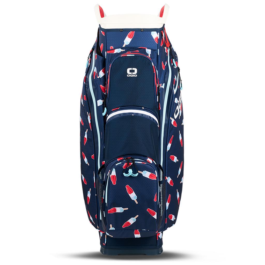 Golf-Cartbag OGIO All Elements Silencer 2025 mit navyblauem Grundton und rot-weiß-blauen Raketen- und Flammenmotiven.