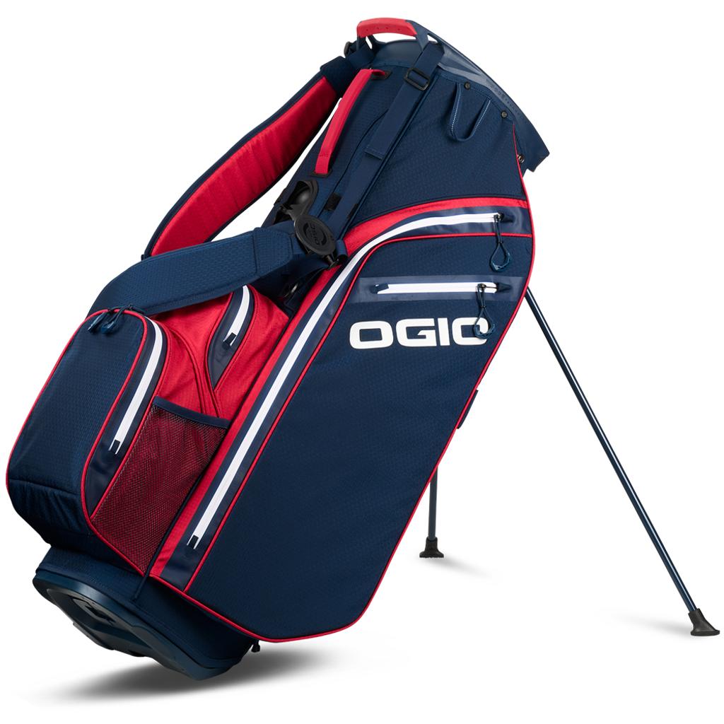 Dunkelblaues OGIO Golf Standbag mit roten Details, weißen Akzenten und mehreren Außentaschen.