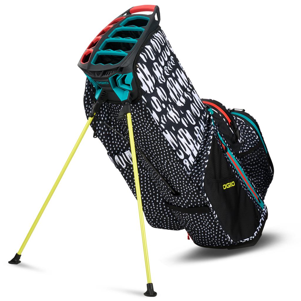 Schwarzes OGIO All Elements Stand Golfbag mit weißem Konfetti-Muster und gelben Standbeinen.