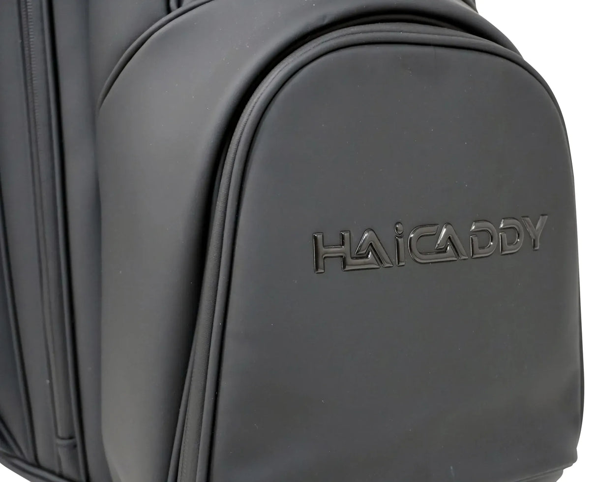 Schwarze Golfbag-Tasche mit glänzendem Haicaddy-Logo und magnetischer Fronttasche.